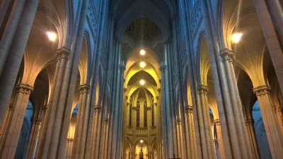 The tall stone arches of the inside of a cathedral