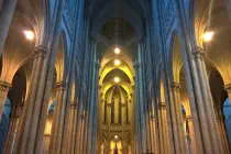 The tall stone arches of the inside of a cathedral