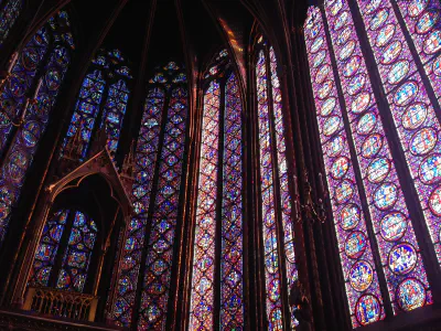 A tall wall of stained glass windows inside a church