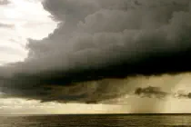 A dark, ominous storm cloud above water