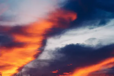 Clouds with the orange light of a sunset shining across them